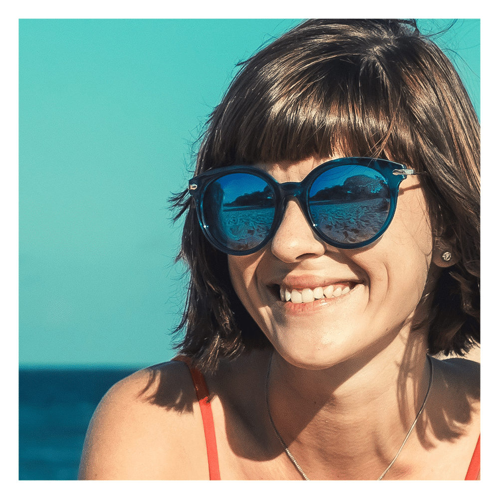 woman by the pool wearing sunglasses