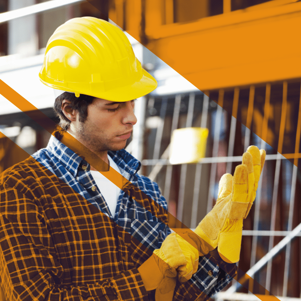 man wearing hardhat while fixing his gloves