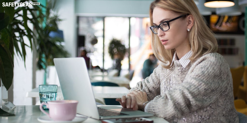 woman with glasses on her laptop