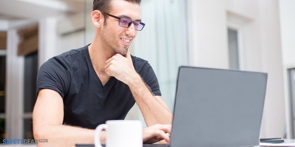 man wearing eyeglasses on his laptop