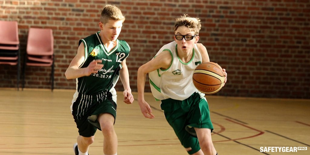 two kids playing basketball wearing glasses