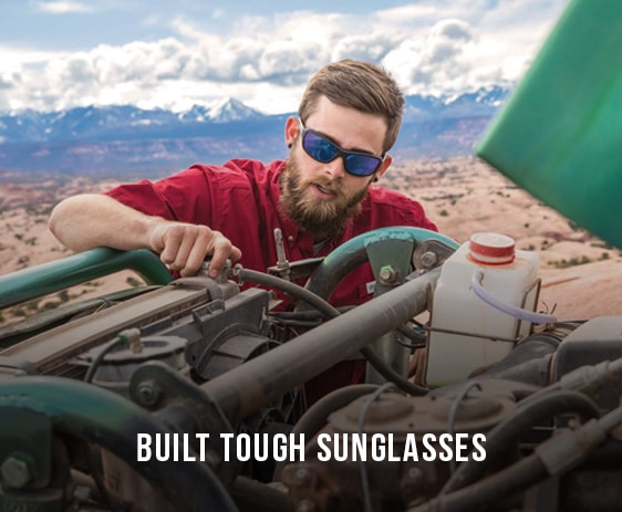 man fixing car engine wearing prescription sunglasses