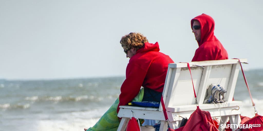 lifeguards on their shift by the beach wearing red