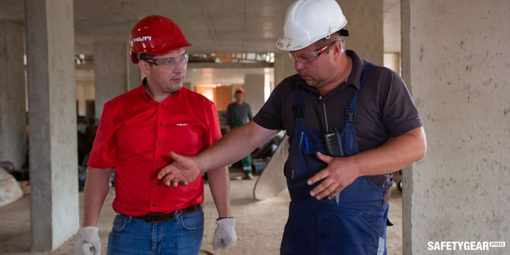 men with hardhats talking 