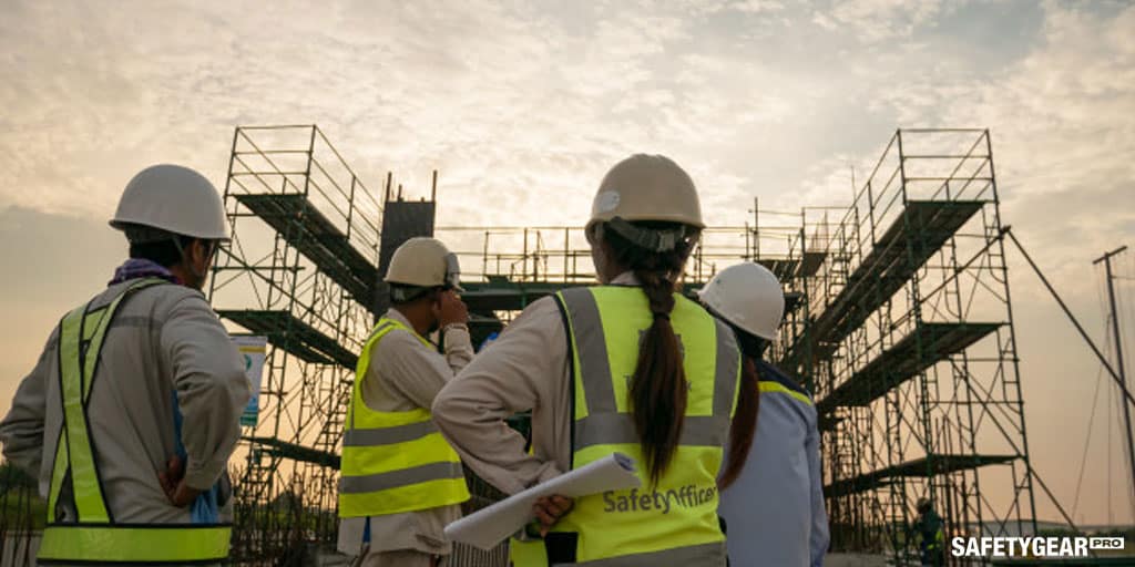 Plantation workers wearing hardhats