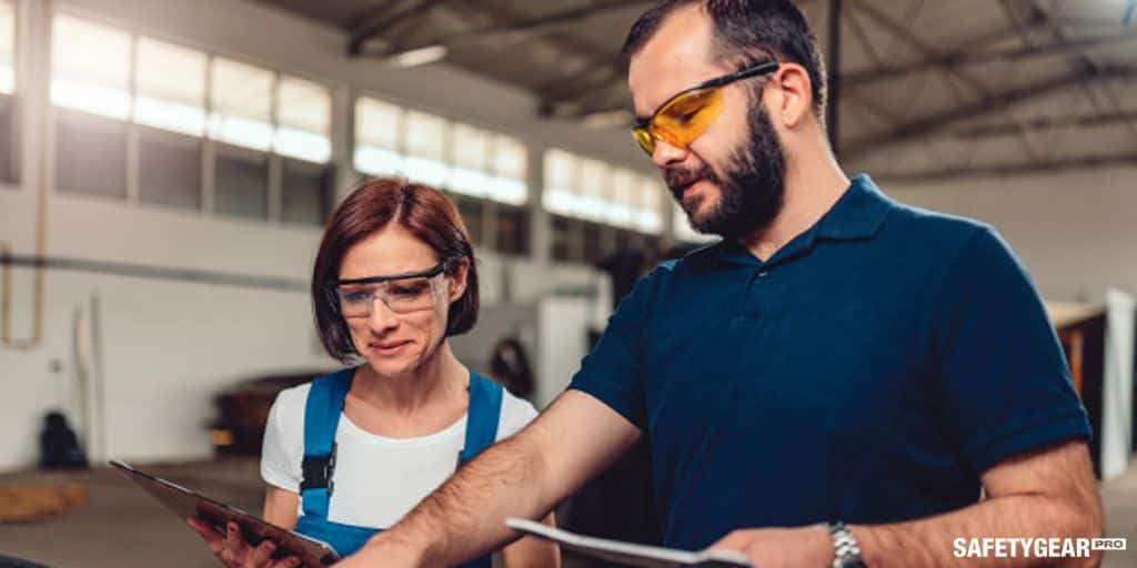 man and woman wearing safety glasses at work