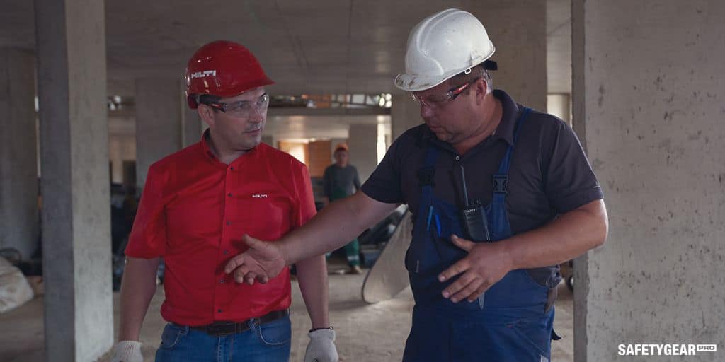 men wearing safety glasses at construction site
