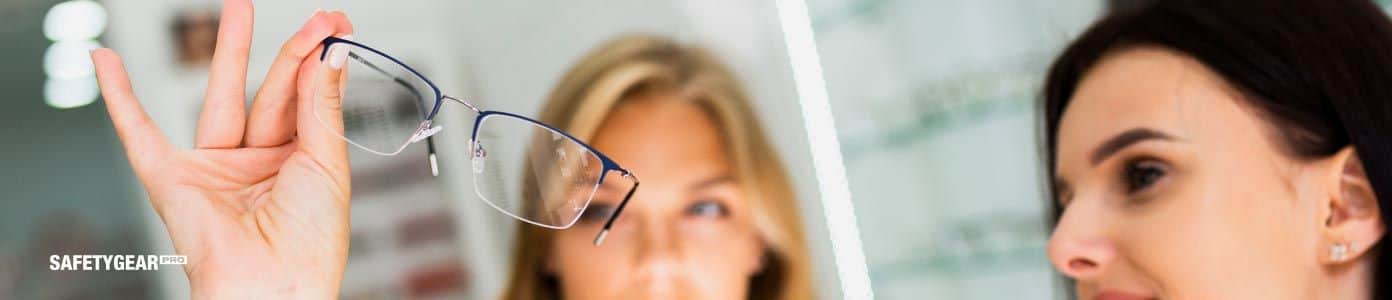woman holding bifocal glasses