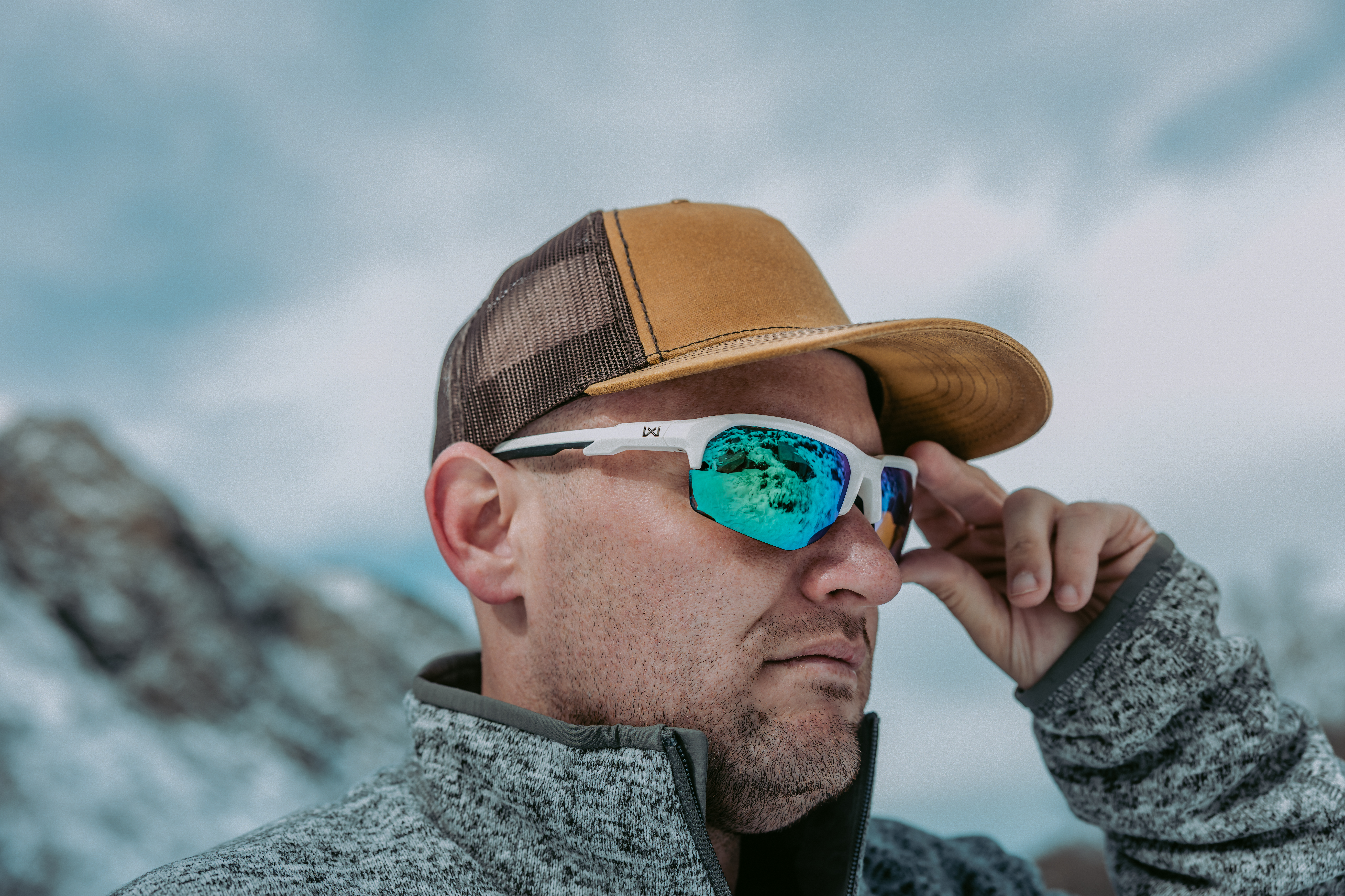 Man wearing prescription sunglasses hiking in the winter