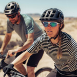man and woman riding bikes with prescription sunglasses