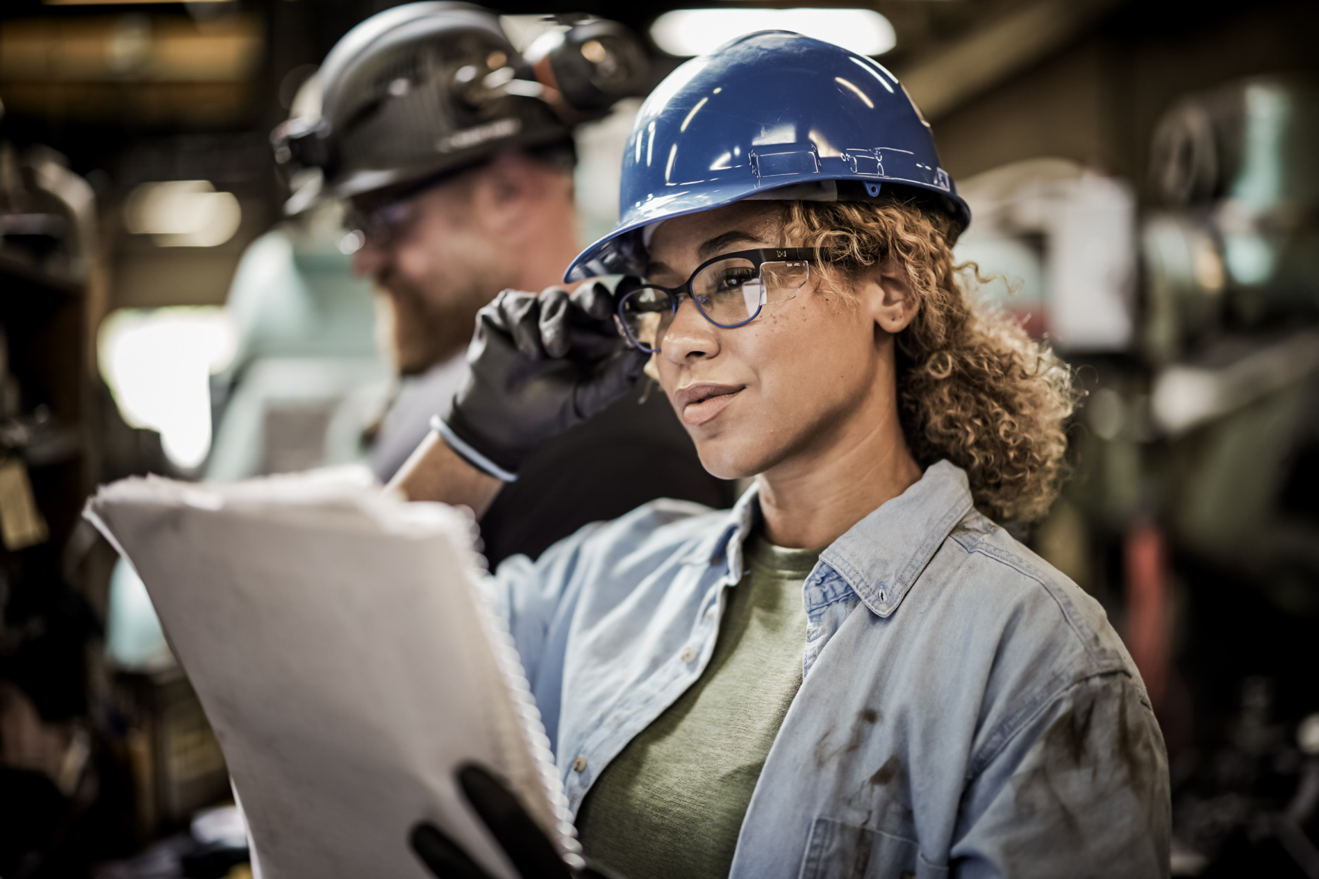 Woman in factory with safety glasses